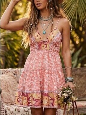 Angie dress is a vibrant boho-chic sundress featuring a blend of warm pink